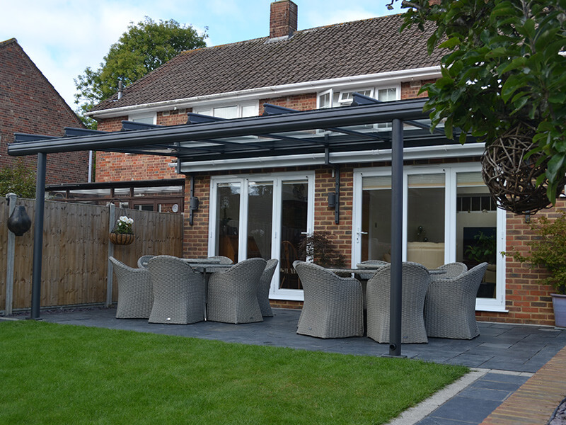 black frame glass awning in garden with artificial grass